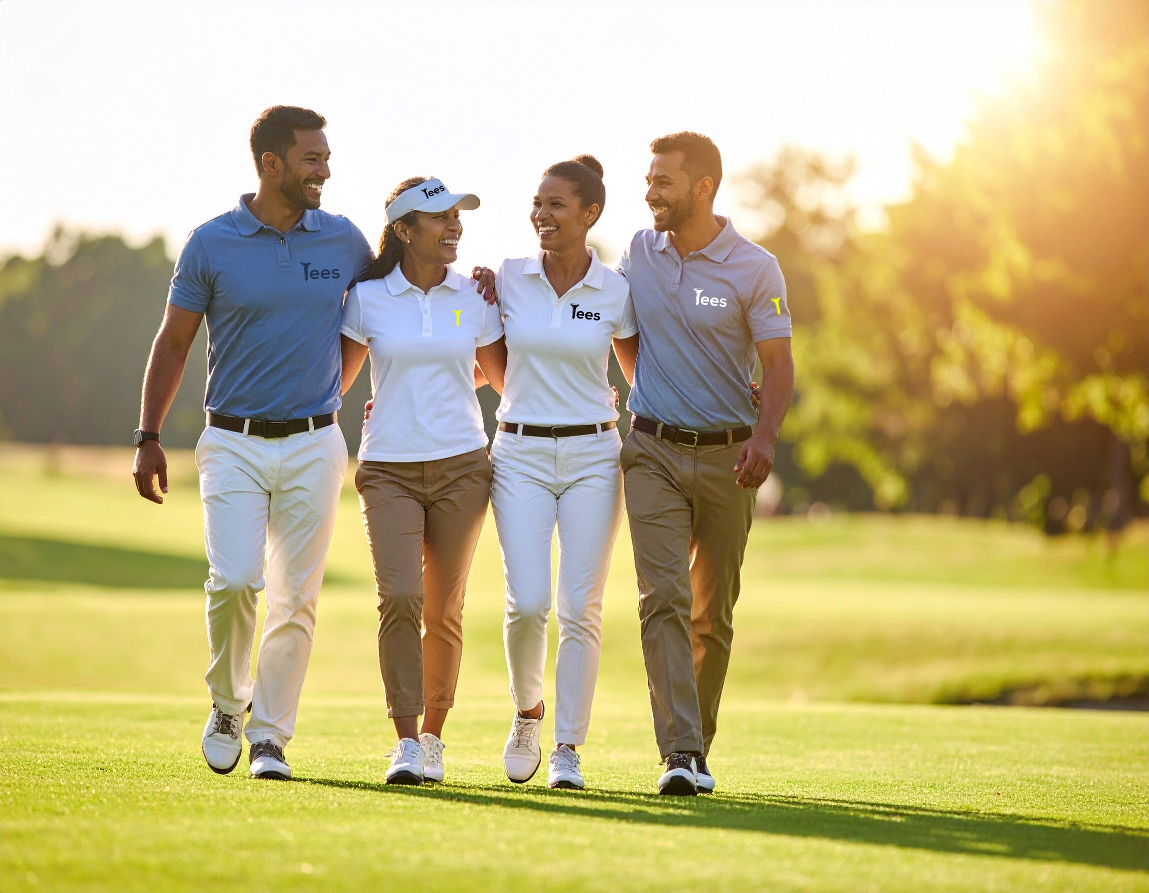 Four people walking on a golf course with 'Tees' branding.